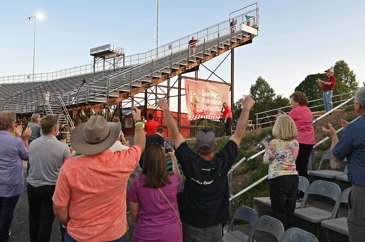 Fans cheer the unveiling of the Benny Parsons Grandstand at North Wilkesboro Speedway on Wednesday, May 10, 2023. North Wilkesboro Speedway held an open house for fans to see the renovations to the track. The speedway will host the NASCAR All-Star race on Sunday, May 21, 2023. The last race ran at the speedway was in 1996.