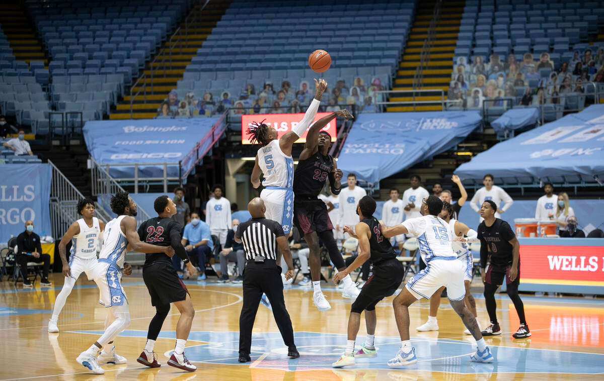 North Carolina’s Armando Bacot (5) controls the jump ball against NCCU’s Nehemia Kabeya (25) on Saturday, December 12, 2020 at the Smith Center in Chapel Hill, N.C. Only a limited number of fans, mostly family and friends of players were allowed at the second home game for the Tar Heels this season due to the COVID-19 pandemic.