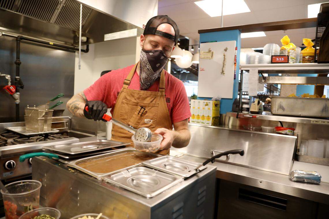 Marshall Davis prepares an order at Ex-Voto Cocina Nixtamal located in the Durham Food Hall on Thursday, Aug. 20, 2020. The restaurant has shifted to Burrito Bodega as a temporary takeout pop-up during the pandemic.