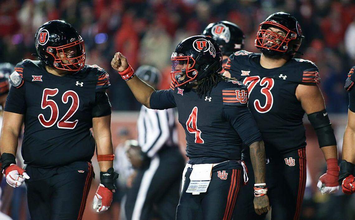 SALT LAKE CITY, UTAH - NOVEMBER 22: Devon Dampier #4 of the Utah Utes celebrates with teammates Michael Mokofisi #52 and Tanoa Togiai #73 after scoring the game-winning touchdown during the second half of a game against the Kansas State Wildcats at Rice-Eccles Stadium on November 22, 2025 in Salt Lake City, Utah. (Photo by Chris Gardner/Getty Images)