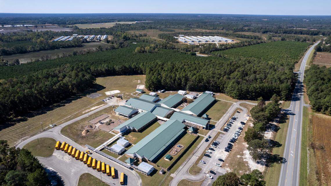 A bill filed this week would require North Carolina legislators to consider existing pollution nearby when making permitting decisions, and a public meeting Saturday in Clinton will address the same idea. This photo shows two large chicken operations near Union Elementary School in Clinton.