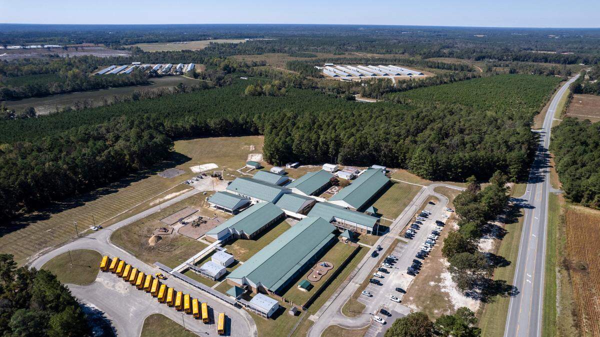 A bill filed this week would require North Carolina legislators to consider existing pollution nearby when making permitting decisions, and a public meeting Saturday in Clinton will address the same idea. This photo shows two large chicken operations near Union Elementary School in Clinton.