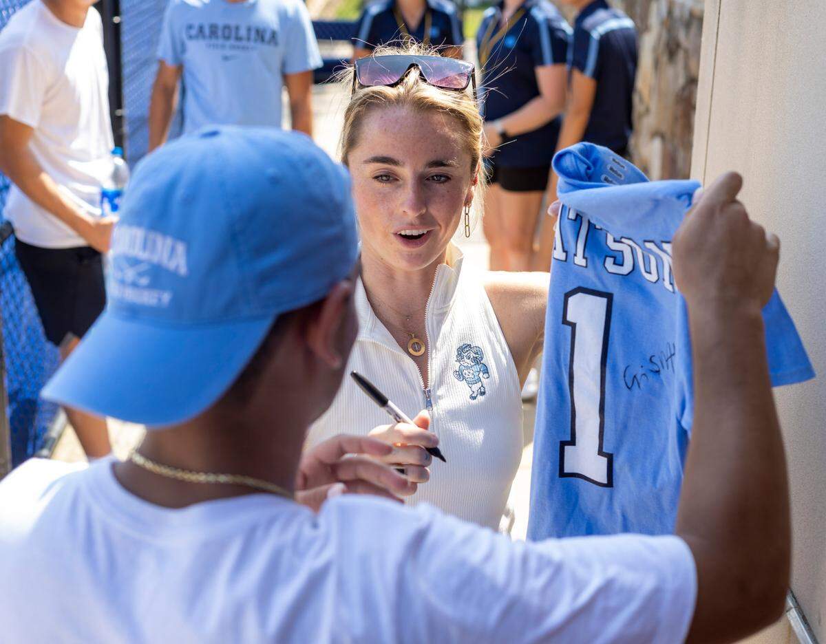 North Carolina field hockey coach Erin Matson autographs one of her jersey’s for a fan after the Tar Heels’ loss to Iowa on Sunday, August 27, 2023 at Karen Shelton Stadium in Chapel Hill, N.C.