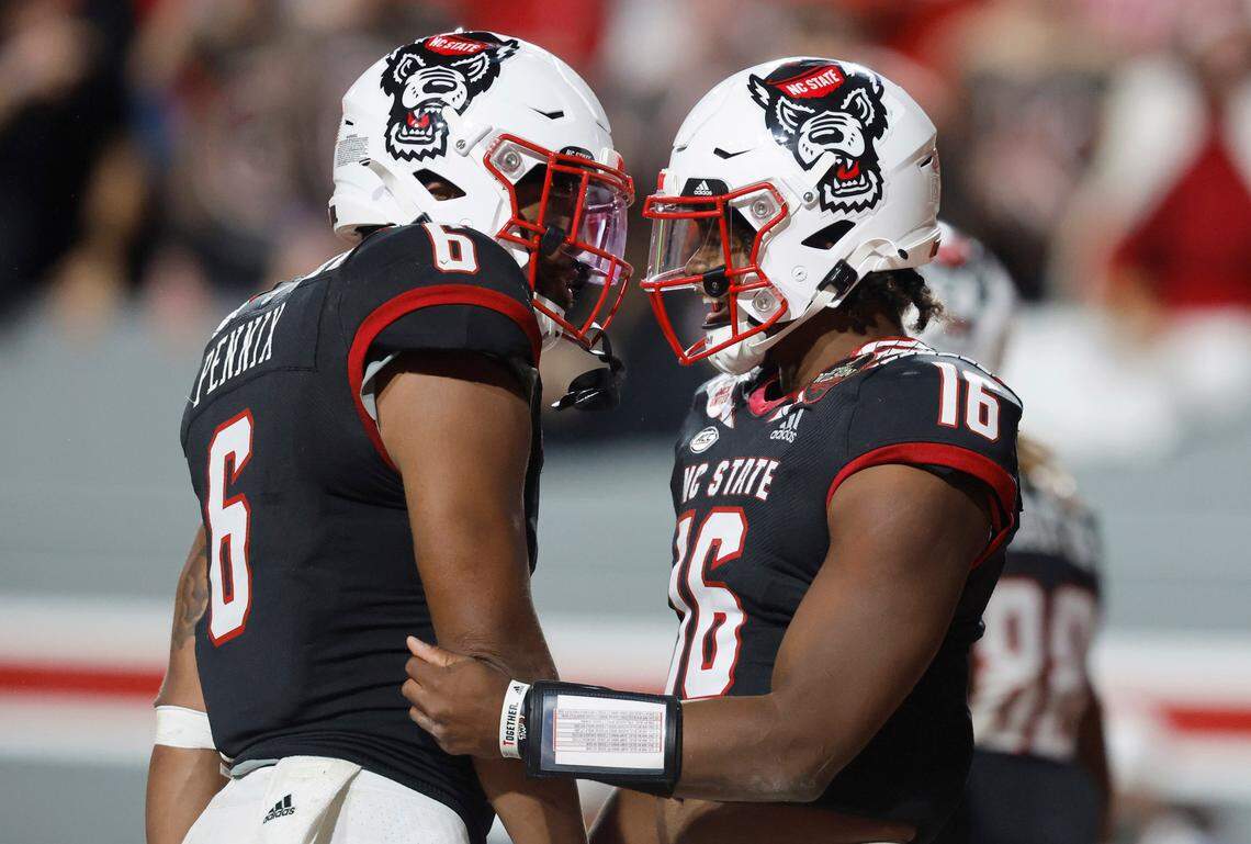 N.C. State quarterback MJ Morris (16) celebrates with Trent Pennix (6) after Pennix scored on a 7-yard touchdown reception during the second half of N.C. State’s 22-21 victory over Virginia Tech at Carter-Finley Stadium in Raleigh, N.C., Thursday, Oct. 27, 2022.