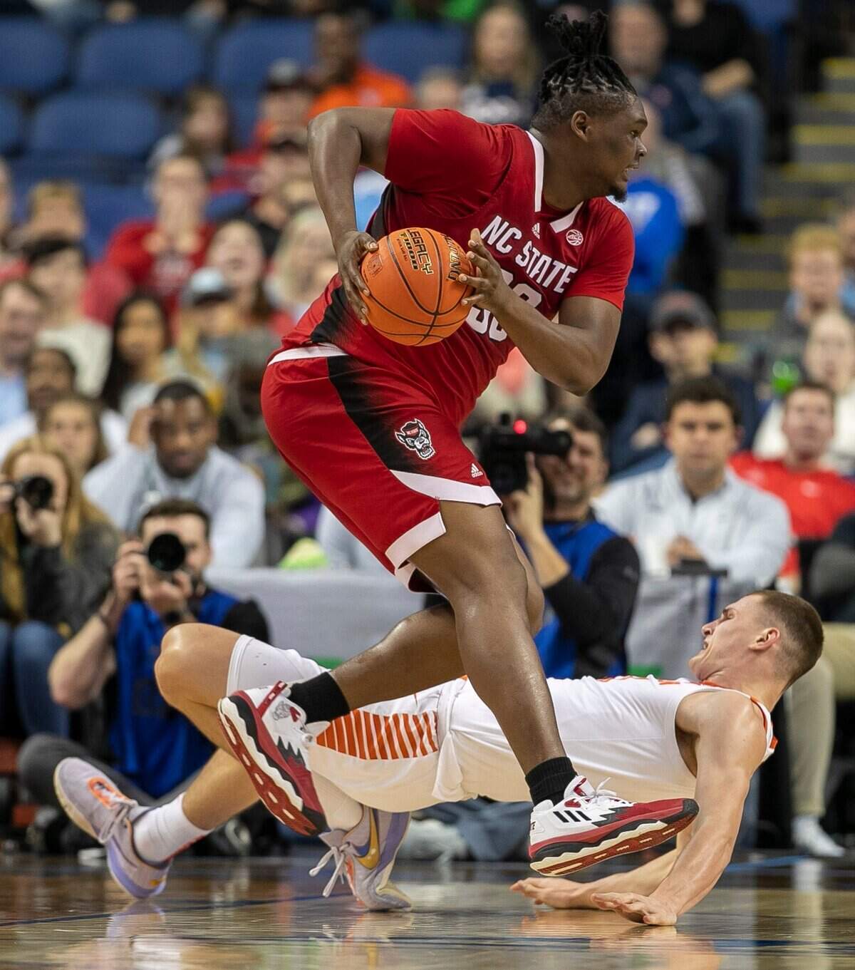 N.C. State’s D.J. Burns (30) collides with Clemson’s Ben Middlebrooks (10) in the first half during the third round of the ACC Tournament on Thursday, March 9, 2023 at the Greensboro Coliseum in Greensboro, N.C.