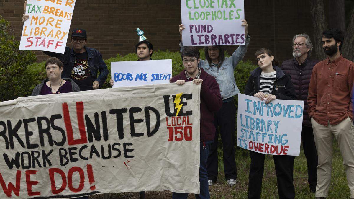 Wake County library workers and supporters demonstrate outside the Wake County Commons Building in Raleigh before a public hearing on the county’s proposed fiscal 2027 budget on Monday, May 11, 2026. Protesters say chronic understaffing and reductions in staff hours are affecting library programming and services.