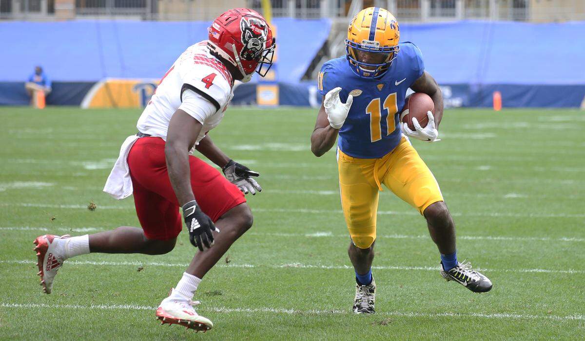 Pittsburgh Panthers wide receiver Taysir Mack (11) runs after a catch as N.C. State’s Cecil Powell (4) defends during their game Saturday, Oct. 3, 2020.