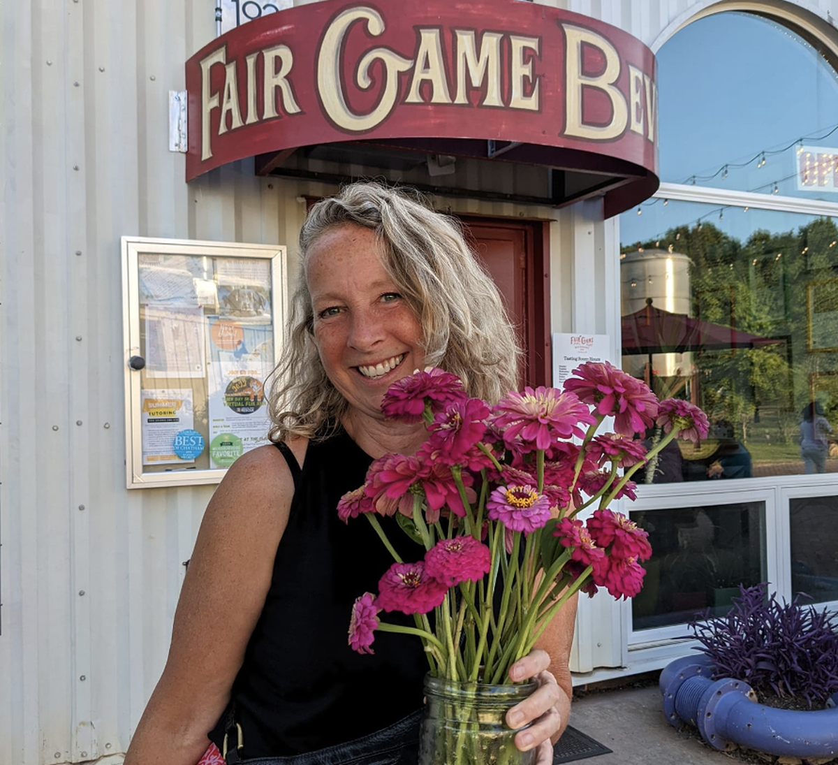Tami Schwerin, 59, poses with a bouquet of flowers. Schwerin is the founder of Pittsboro’s annual Death Faire, a celebration of dying and grief.