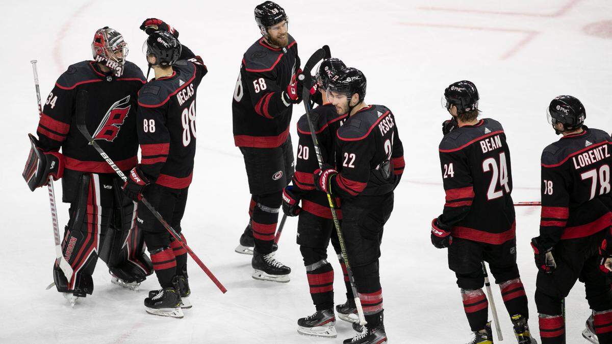 Carolina Hurricanes’ goalie Petr Mrazek (34) is embraced by Martin Necas (88) as the team celebrates their 4-1 victory over Nashville on Thursday, April 15, 2021 at PNC Arena in Raleigh, NC.