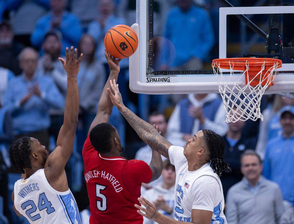 North Carolina’s Armando Bacot (5) and Jae’Lyn Withers (24) defend Louisville’s Brandon Huntley-Hatfield (5) in the second half on Wednesday, January 17, 2024 at the Smith Center in. Chapel Hill, N.C.