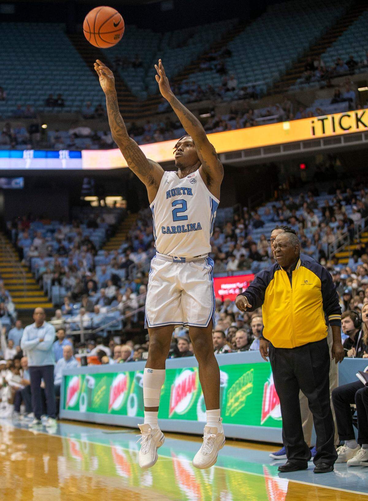 North Carolina’s Caleb Love (2) launches a three-point attempt in front of the Johnson C. Smith bench during an exhibition game on Friday, October 28, 2022 at the Smith Center in Chapel Hill, N.C. Love lead all scores with 20 points.