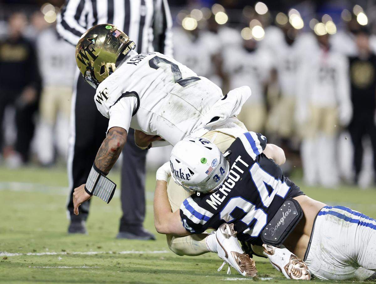 Duke’s Luke Mergott tackles Wake Forest quarterback Robby Ashford during the second half of the Blue Devils’ 49-32 win on Saturday, Nov. 29, 2025, at Wallace Wade Stadium in Durham, N.C.
