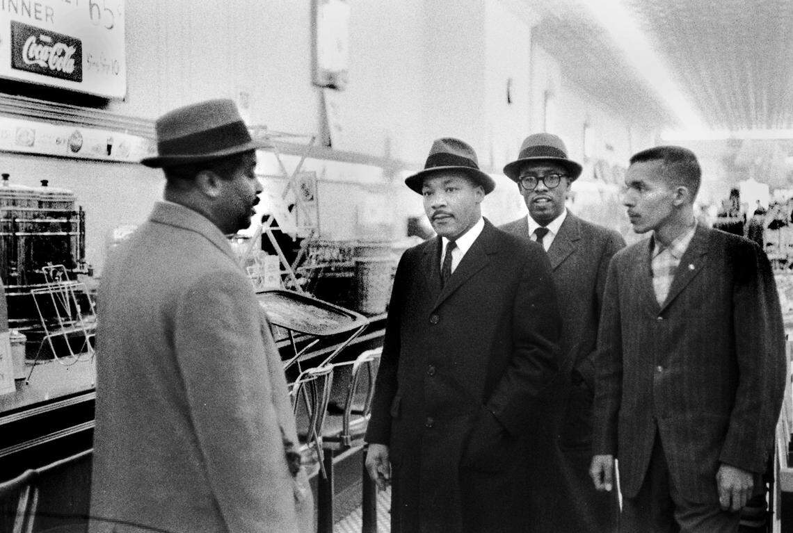 Civil rights leader Ralph Abernathy speaks with Dr. Martin Luther King Jr, and local civil rights leaders as they visit Woolworths in downtown Durham February 16 1960.