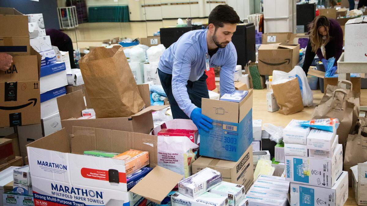 Rex Wellness Center of Raleigh employees prepare to redistribute donations of personal protective equipment and sanitary supplies at the center Monday, March 23, 2020. UNC Health and WakeMed are accepting donations of medical supplies to help protect workers and patients during the COVID-19 response. Donation sites and more information can be found at https://www.unchealthcare.org/coronavirus/ways-to-help/.