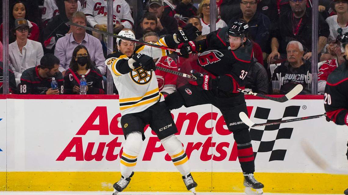 Boston Bruins left wing Erik Haula (56) hits Carolina Hurricanes right wing Andrei Svechnikov (37) during the first period in game one of the first round of the 2022 Stanley Cup Playoffs at PNC Arena.