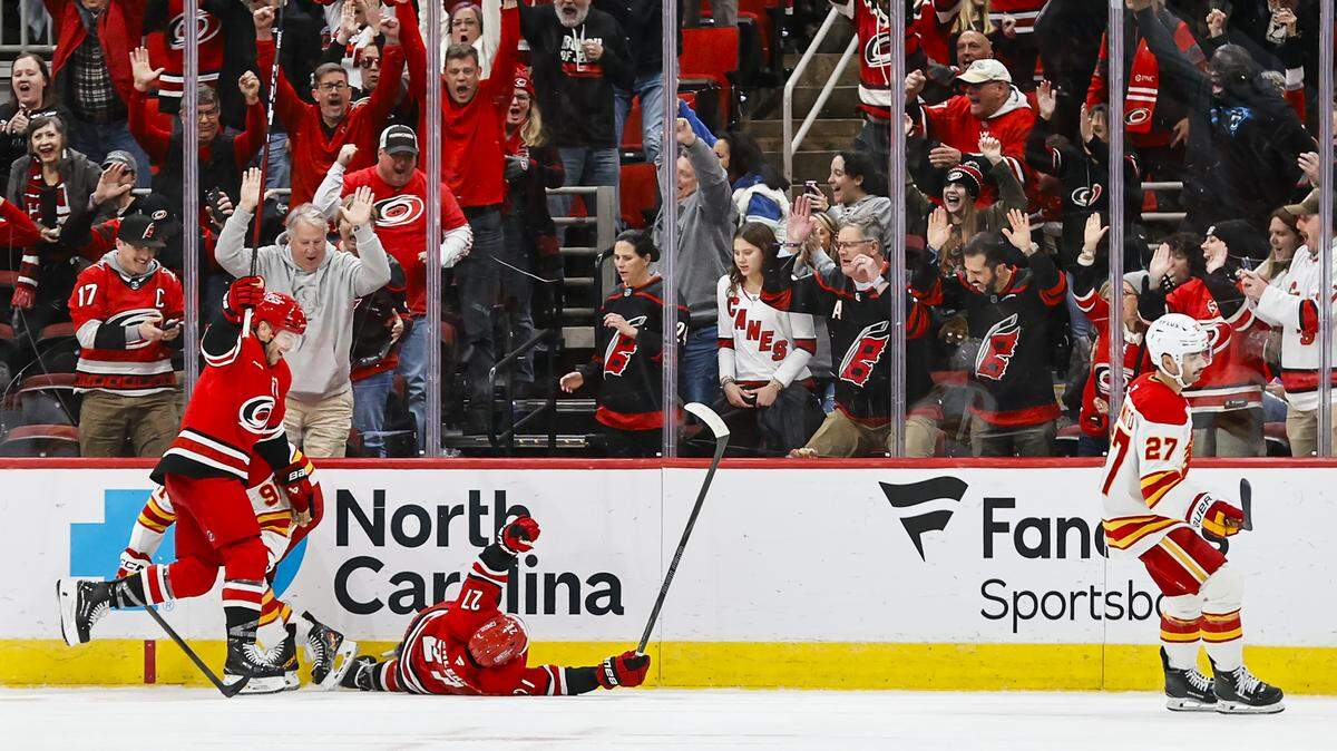 Carolina Hurricanes forward Nikolaj Ehlers (27) celebrates his goal with Taylor Hall (71) in overtime against the Calgary Flames at Lenovo Center on Nov. 30, 2025 in Raleigh, North Carolina.
