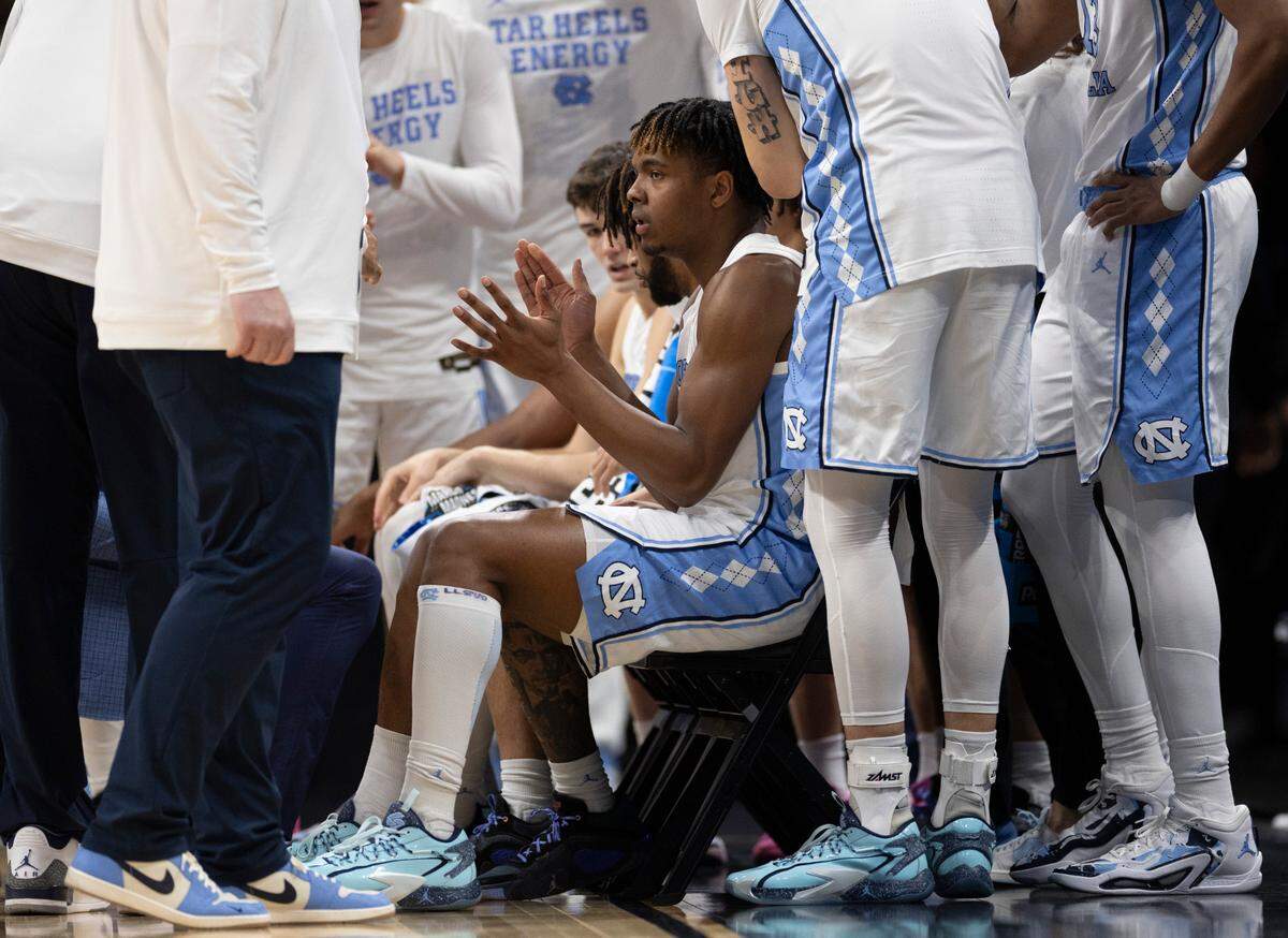 North Carolina’s Harrison Ingram (55) and fellow starters huddle with coach Hubert Davis prior to their game against Wagner on Thursday, March 21, 2024 during the NCAA Tournament at Spectrum Center in Charlotte, N.C.