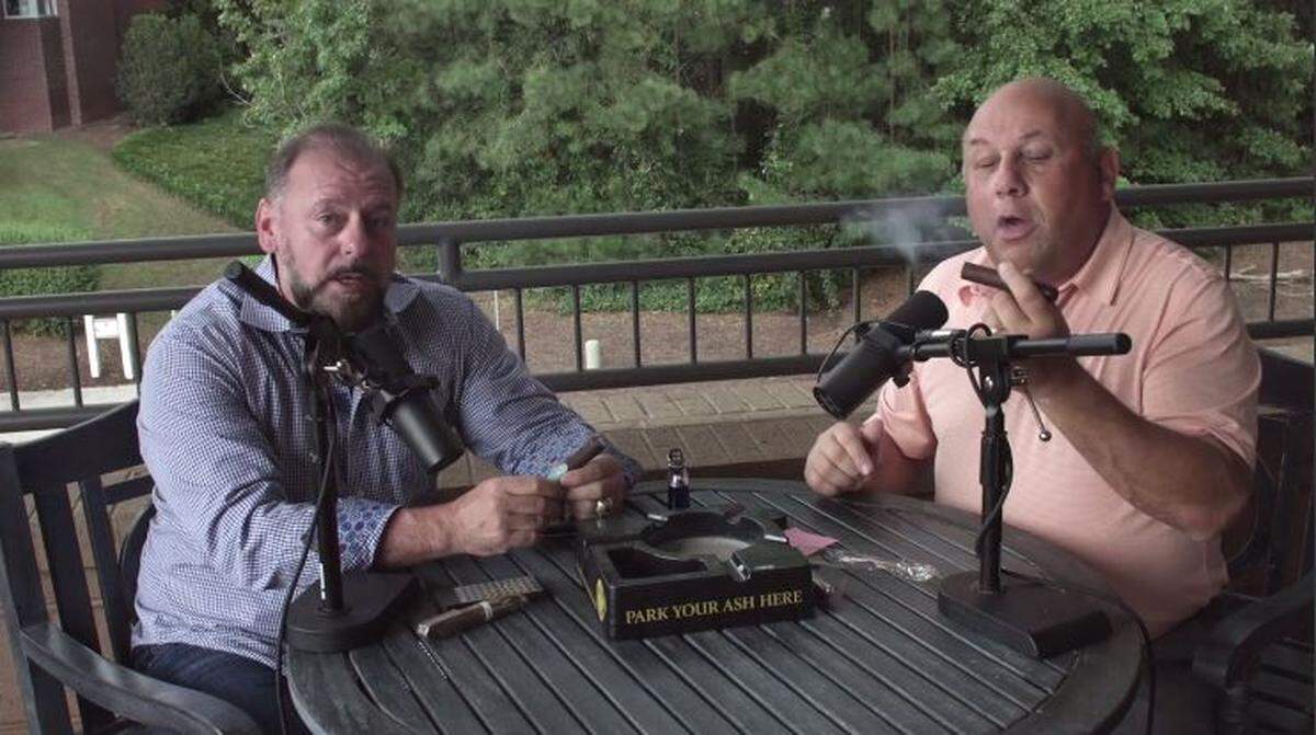 Former Carolina Hurricanes radio broadcaster Chuck Kaiton, right, enjoys a cigar on an episode of his new video podcast with financial planner Pete D’Arruda, the Live Happy Show.