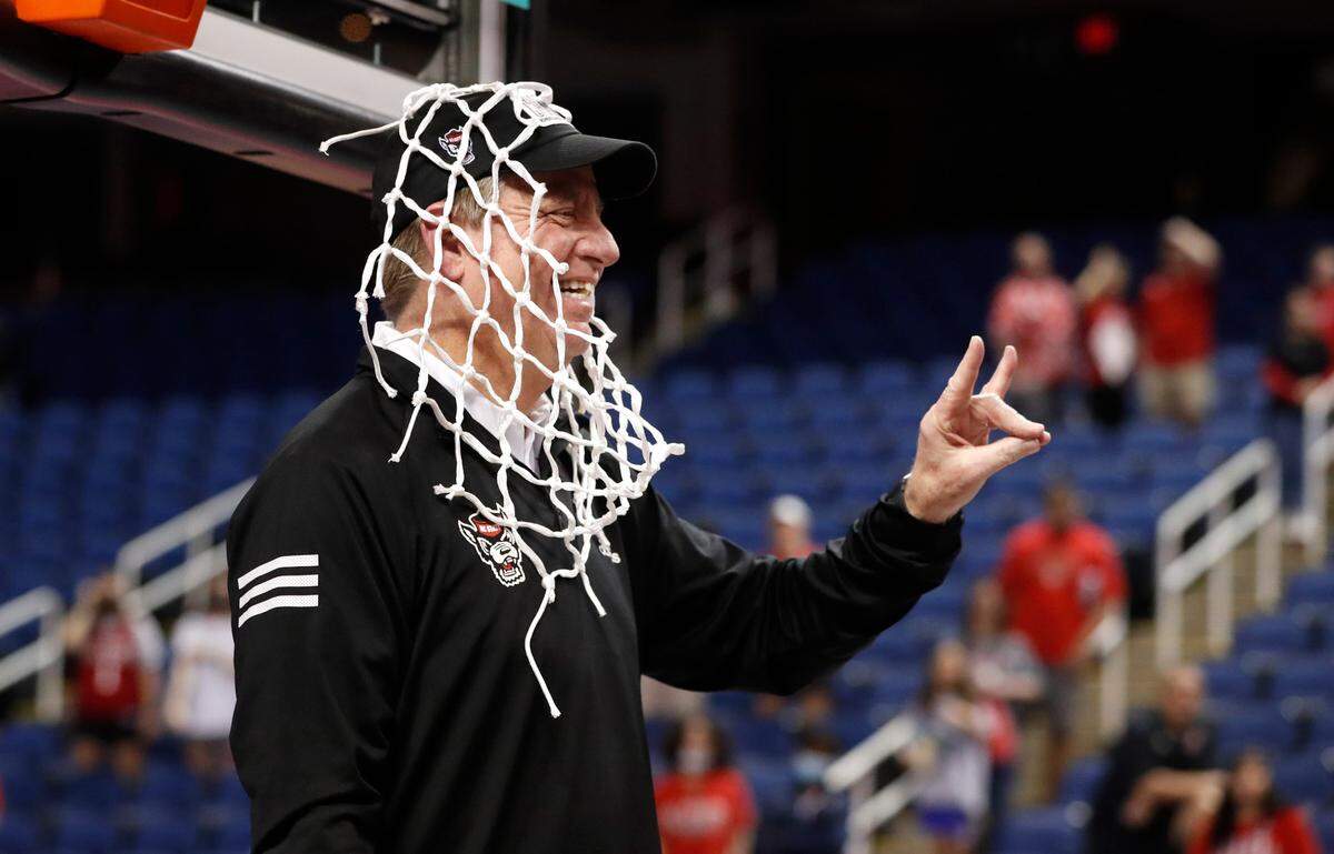 N.C. State head coach Wes Moore celebrates after cutting down the net after the Wolfpack’s 60-47 victory over Miami to win the ACC women’s basketball tournament in Greensboro, N.C., Sunday, March 6, 2022.