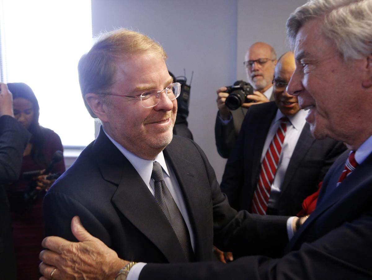 Peter Hans, left, is congratulated by well-wishers after it was announced Tuesday he would be the president of the North Carolina community college system.
