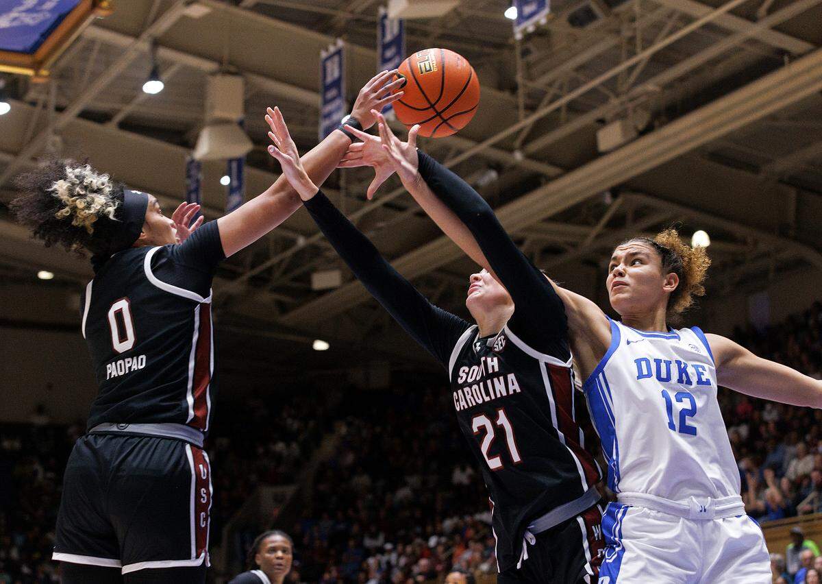 South Carolina’s Te-Hina Paopao and Chloe Kitts wrestle Duke’s Delaney Thomas for a rebound during the second half of the Blue Devils’ 77-61 loss on Sunday, Dec. 3, 2023, at Cameron Indoor Stadium in Durham, N.C.