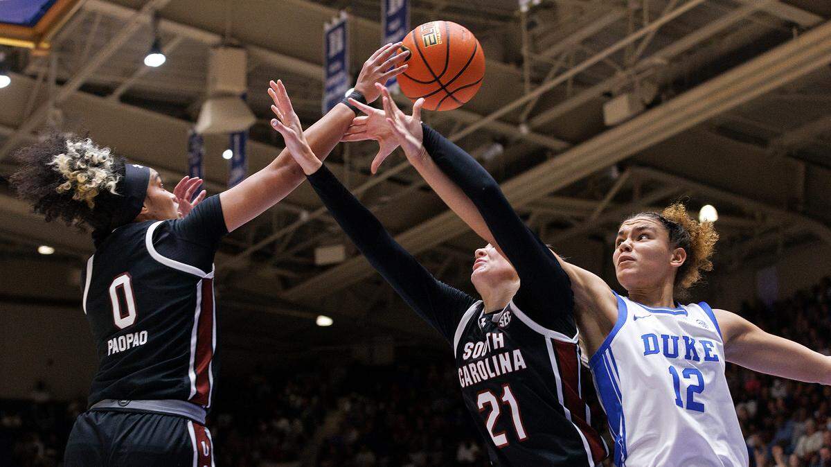 South Carolina’s Te-Hina Paopao and Chloe Kitts wrestle Duke’s Delaney Thomas for a rebound during the second half of the Blue Devils’ 77-61 loss on Sunday, Dec. 3, 2023, at Cameron Indoor Stadium in Durham, N.C.