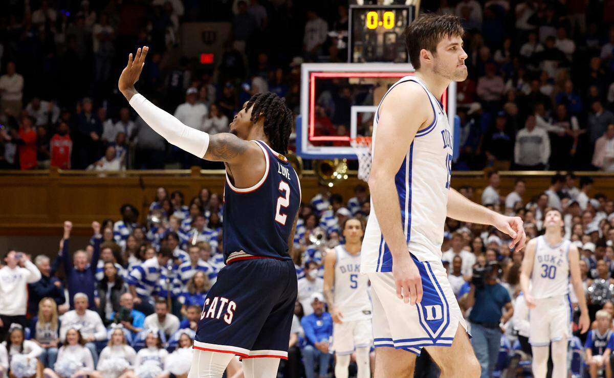 Arizona’s Caleb Love (2) waves to the Cameron Crazies as Duke’s Ryan Young (15) walks off the court after Arizona’s 78-73 victory over Duke at Cameron Indoor Stadium in Durham, N.C., Friday, Nov. 10, 2023.