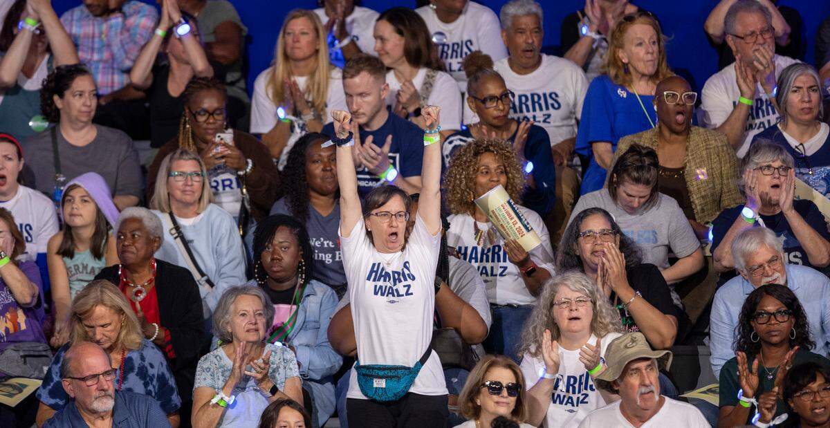 Supporters of Vice President Kamala Harris, the Democratic Presidential nominee, react to a message on women’s rights as they await her arrival on Sunday, October 13, 2024 at Minges Coliseum in Greenville, N.C.