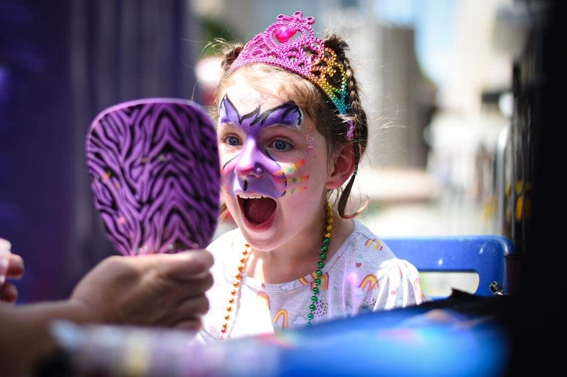 Emersyn Brook, 6, is pictured reacting to her painted face by Beth Rojas of Kathi’s Klowns at the Out! Raleigh Pride Festival in downtown Raleigh on Saturday, June 25, 2022.
