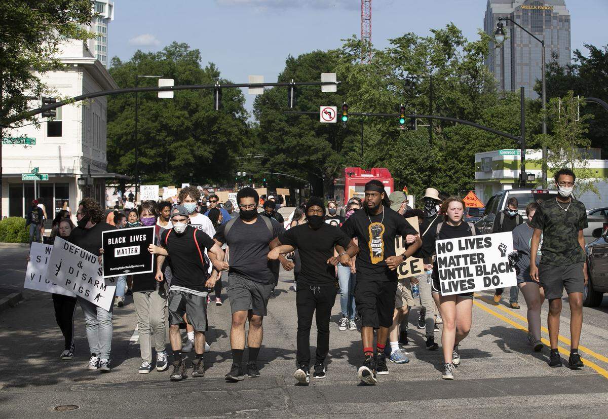 Protesters march on Hillsborough Street from the Capitol to the North Carolina GOP headquarters for a rally on Tuesday, June 2, 2020 in Raleigh, N.C.