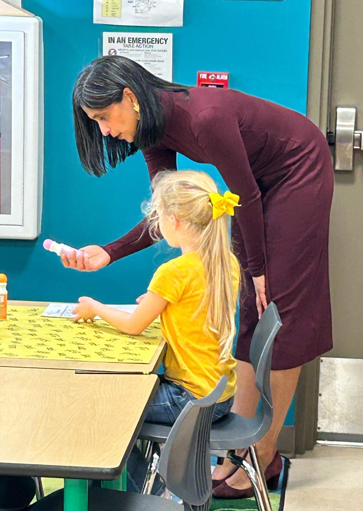 Second lady Usha Vance helps a kindergartner at DeLalio Elementary on Marine Corps Air Station New River on a pre-Thanksgiving visit.