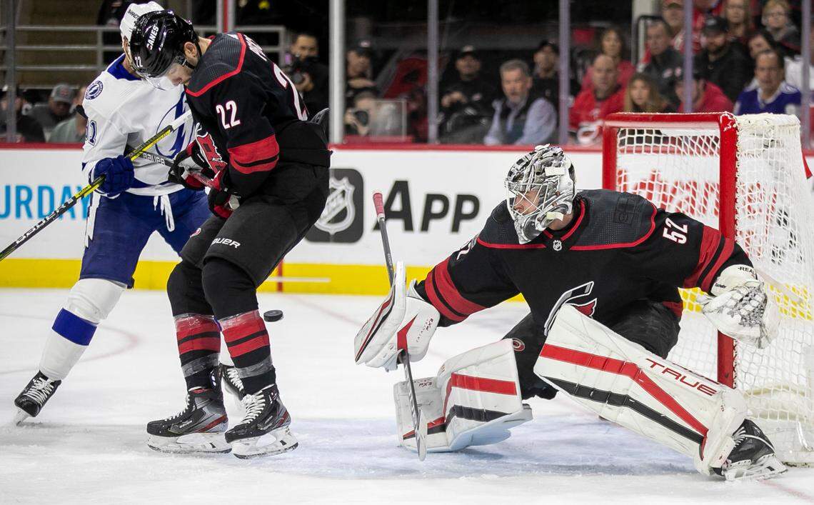 Carolina Hurricanes’ Brett Pesce (22) lets the puck get past him as goalie Pytor Kochetkov (52) defends the goal during the first period against Tampa Bay on Tuesday, March 27, 2023 at PNC Arena in Raleigh, N.C.