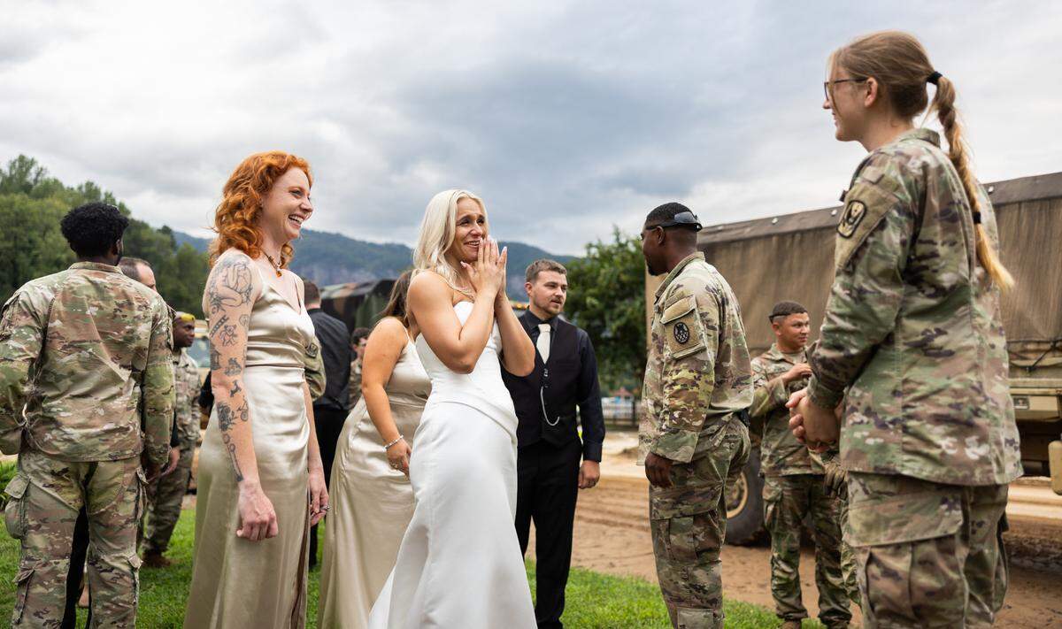 The North Carolina National Guard stops to congratulate the newlyweds, Sereyna and her husband Gavin Walker in Lake Lure, N.C. on Saturday, September 28, 2024.