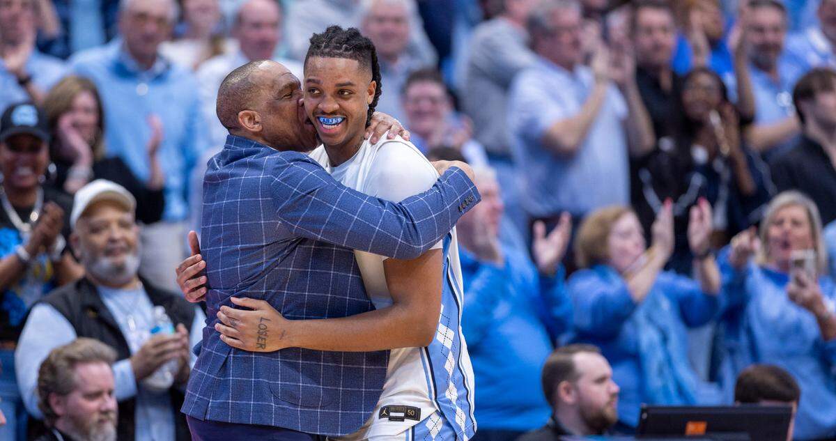 North Carolina’s Armando Bacot (5) gets a hug and a kiss from coach Hubert Davis as he leaves the game with 14 points in the Tar Heels’ 84-51 victory over Noter Dame, and Bacot’s final home game on Tuesday, March 5, 2023 at the Smith Center in Chapel Hill, N.C.