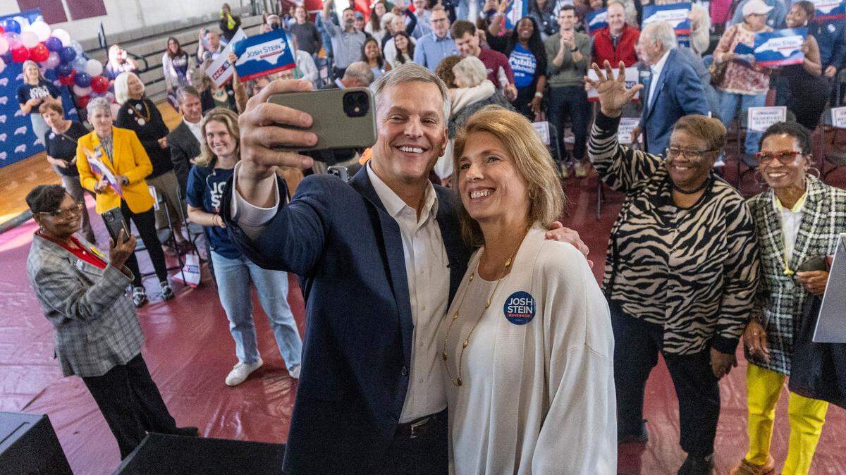 North Carolina Attorney General Josh Stein poses for a selfie with his wife Anna Stein at an October 10, 2023 rally to kick off his campaign for governor at Shaw University in Raleigh.