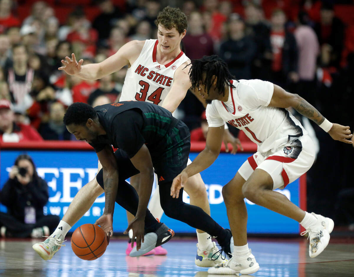N.C. State’s Ben Middlebrooks and Jayden Taylor pressure Miami’s Bensley Joseph during the first half of the Wolfpack’s 74-68 win on Tuesday, Jan. 30, 2024, at PNC Arena in Raleigh, N.C.
