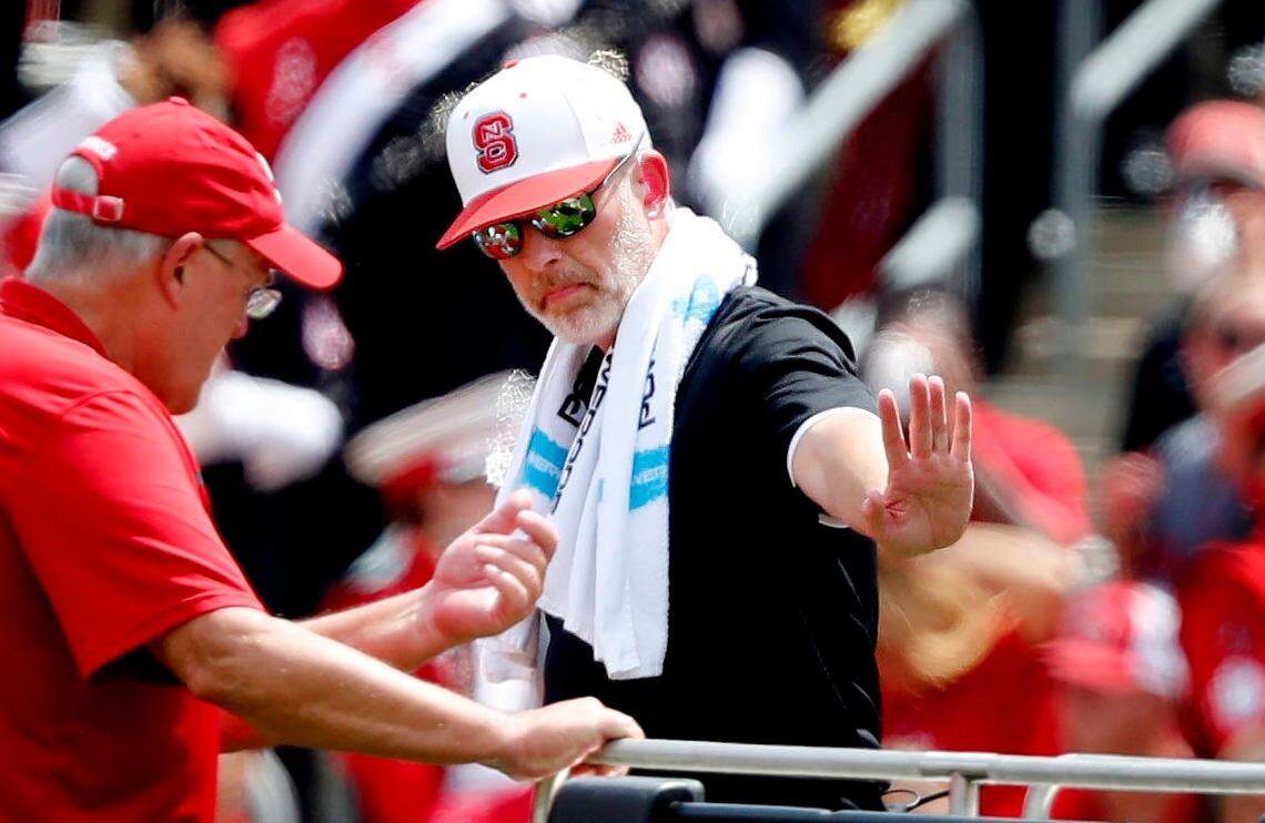 Robert M. Murphy Jr. (center in white hat), who was listed as an associate athletic director and director of sports medicine at N.C. State, helps a crew move an injured football player in the first half of N.C. State’s game against JMU at Carter-Finley Stadium in Raleigh, N.C., Saturday, Sept. 1, 2018.