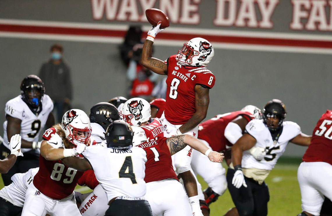 N.C. State running back Ricky Person Jr. (8) throws a two-yard touchdown pass during the second half of N.C. State’s 45-42 victory over Wake Forest at Carter-Finley Stadium in Raleigh, N.C, Saturday, Sept. 19, 2020.