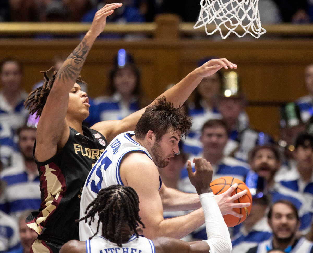 Duke’s Ryan Young pulls down a rebound away from Florida State’s Cam Corhen during the second half of a men’s basketball game at Cameron Indoor Stadium on Saturday, Dec. 31, 2022, in Durham, N.C.