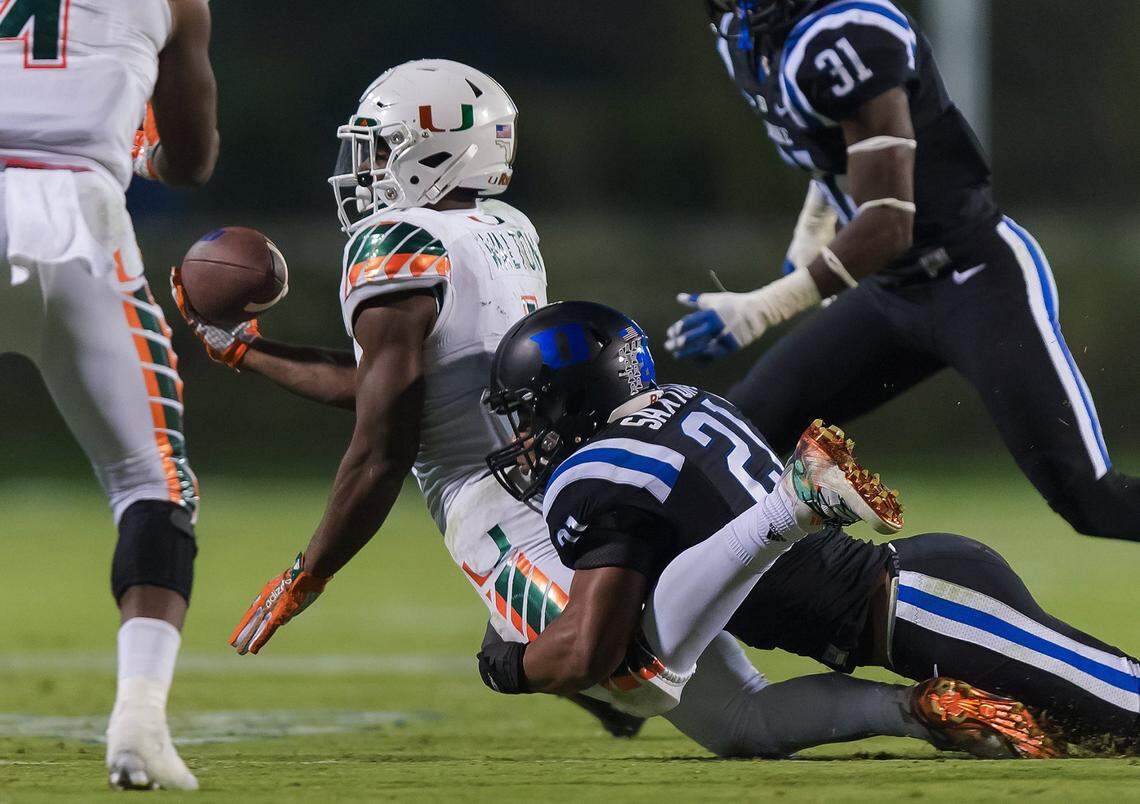 Duke cornerback Alonzo Saxton II tackles Miami’s running back Mark Walton during the kick off in the closing seconds of the game. After a long video review of the play game officials ruled the Hurricane player was not down and gave Miami the touchdown. Miami upset the Blue Devils 30-27 at Wallace Wade Stadium in Durham, N.C. Saturday, October 31, 2015.