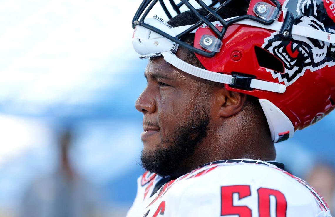 N.C. State’s Grant Gibson (50) takes a break during warmups before the Wolfpack’s game against UNC at Kenan Stadium in Chapel Hill, N.C., Saturday, Oct. 24, 2020.
