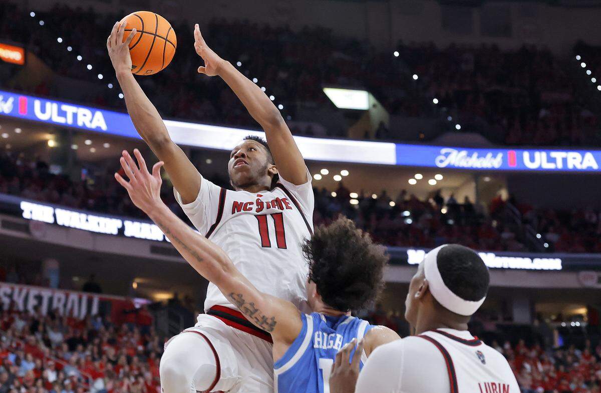N.C. State’s Quadir Copeland drives to the basket past North Carolina’s Zayden High during the second half of the Wolfpack’s 82-58 win on Tuesday, Feb. 17, 2026, at Lenovo Center in Raleigh, N.C.