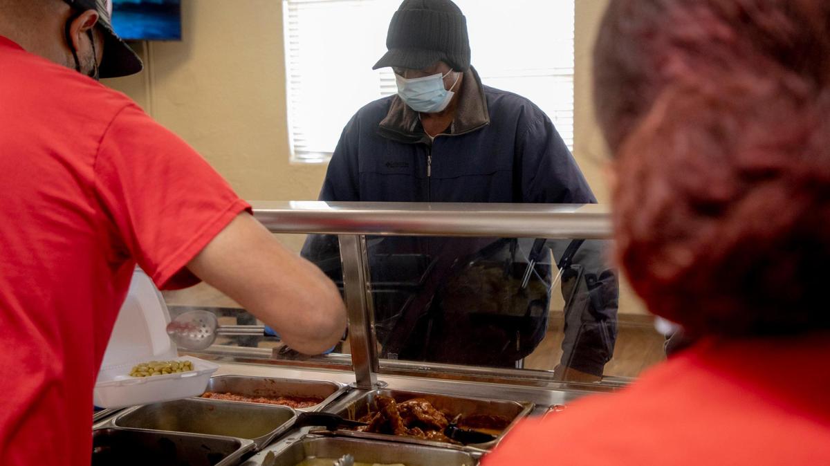 Thomas Harris orders lunch from the Chicken Hut, one of the oldest Black-owned businesses in Durham, which he says he has been a customer of since the 60s, on Thursday, Feb. 4, 2021, in Durham, N.C.