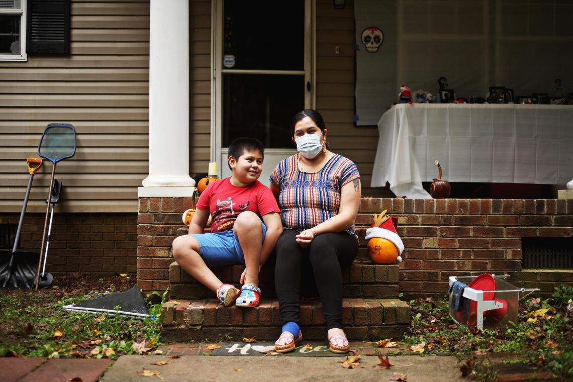 Gael, 8, and his mother, Patricia Obergon, outside of their Durham home on Oct. 28, 2020. The family, whose home language is Spanish, struggle with the school’s English-only online learning system.