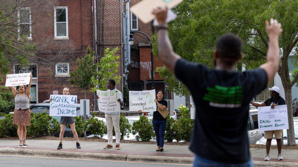 Demonstrators advocate for a higher minimum wage for city workers outside Durham City Hall prior to a budget hearing on Monday, June 3, 2024.