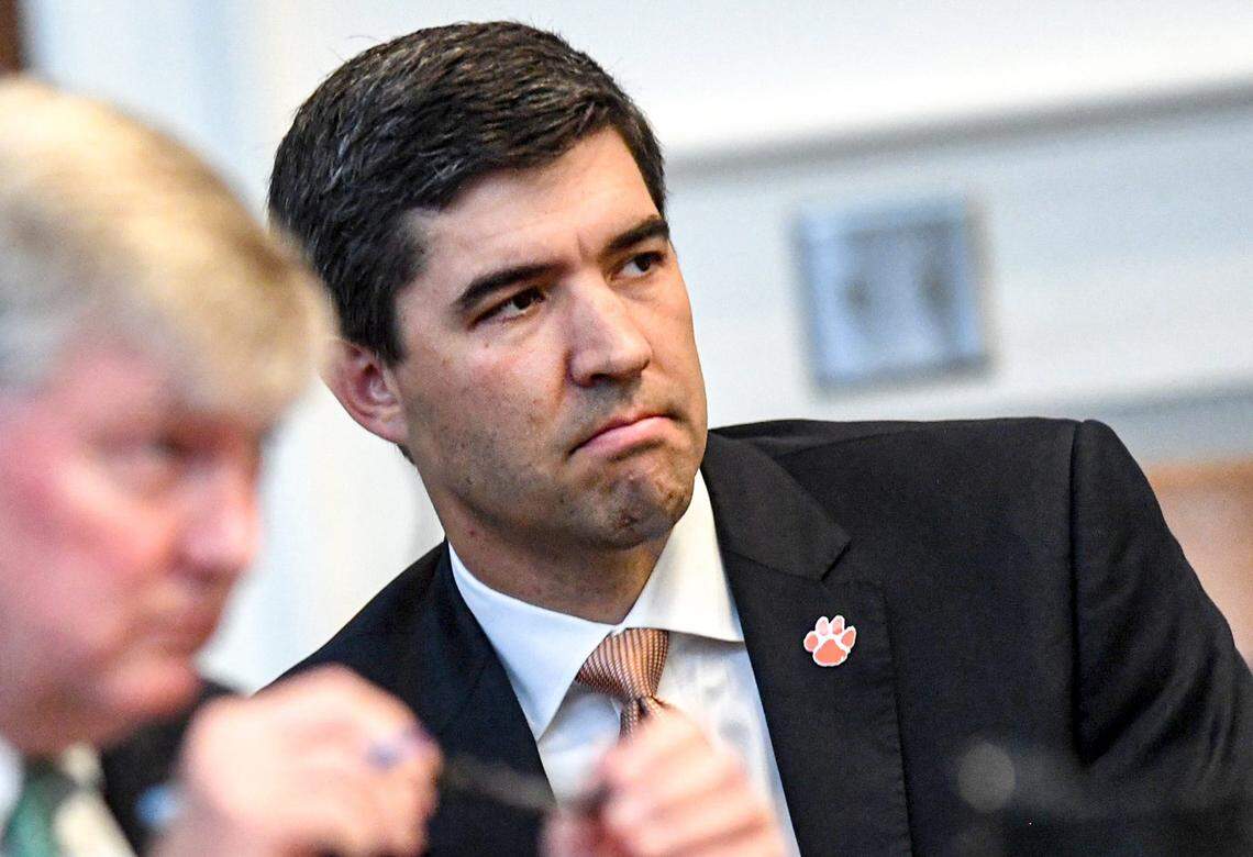 Graham Neff, right, Clemson University Athletic Director looks on as Judge Perry H. Gravely, rules on the university’s motion for summary judgement and the conference’s motion to dismiss, at the Pickens County Courthouse in Pickens, S.C. Friday, July 12, 2024.