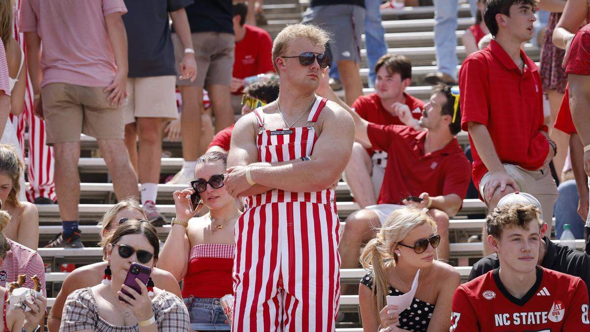 Wolfpack fans react after a Virginia touchdown during the first half of N.C. State’s game against Virginia at Carter-Finley Stadium in Raleigh, N.C., Sat. Sept. 6, 2025.
