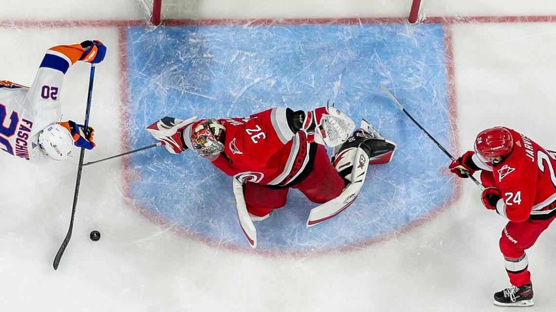 Carolina Hurricanes goalie Antii Raanta (32) defends New York Islanders’ Hudson Fasching (20) during the third period in Game 2 of their Stanley Cup series on Wednesday, April 18, 2023 at PNC Arena in Raleigh, N.C.