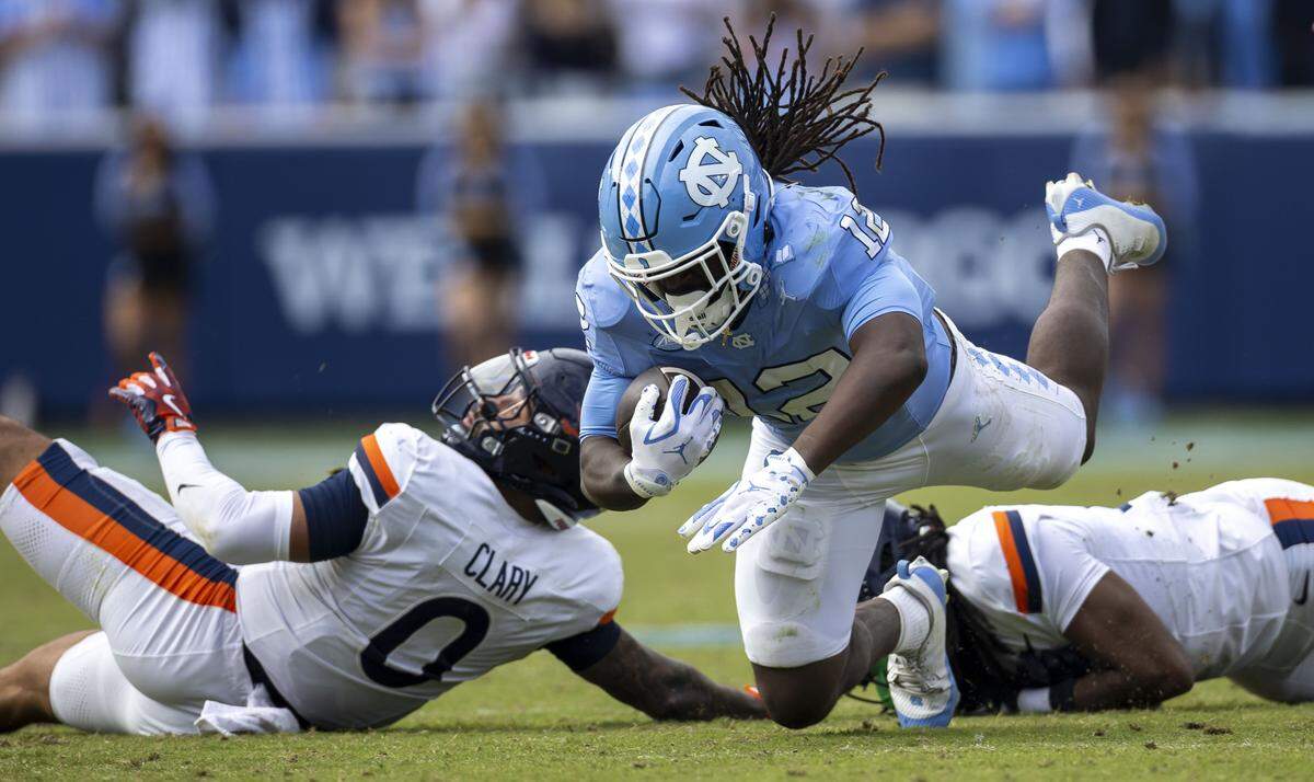 North Carolina running back Demon June (35) dives for extra yardage on a gain of seven yards in the third quarter against Virginia on Saturday, October 25, 2025 at Kenan Stadium in Chapel Hill, N.C. 