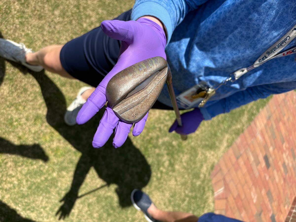 USGA Museum curator Hilary Cronheim holds the wedge that Bryson DeChambeau used to hit his famous bunker shot on the 72nd hole of last June’s U.S. Open. DeChambeau donated the wedge to the USGA in February.